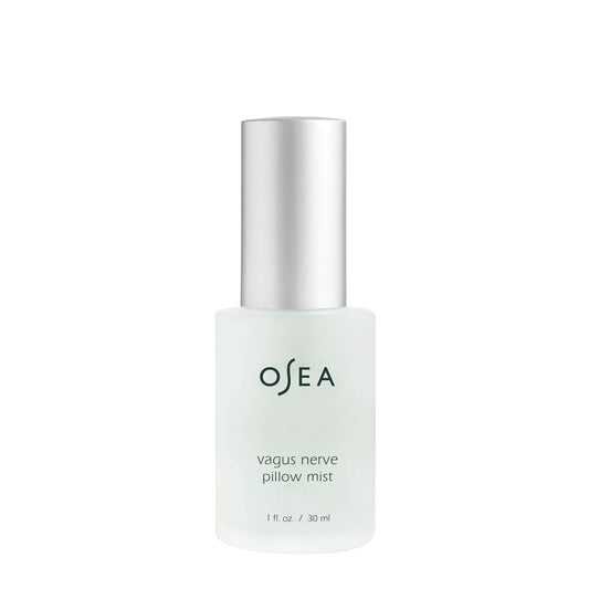 Opaque glass bottle of osea vagus nerve pillow mist with a silver cap, isolated on a white background.